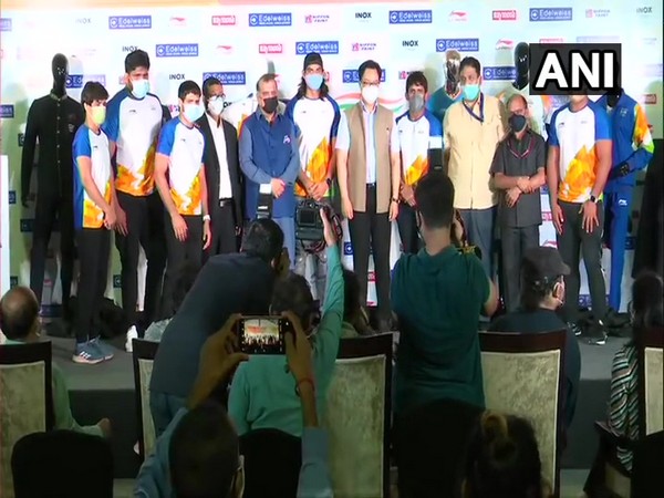 Sports Minister Kiren Rijiju and athletes after unveiling India's Olympic uniform