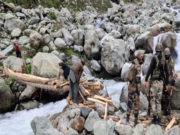 Amid heavy rain and freezing temp at 9000 ft, Indian Army constructs footbridge washed away last night in J-K's Rajouri. [Photo/ANI]