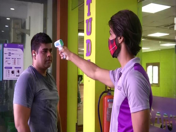 A man gets his temperature checked before entering a gym. (Photo/ANI)