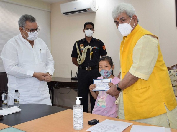 Jammu and Kashmir Lt Governor Manoj Sinha with beneficiary of SASCM