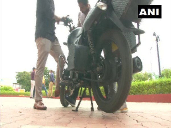 Students developed motorbike that can run on petrol, electricity.