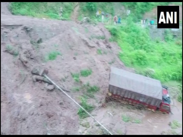 A car and truck fell into a gorge due to flash floods in the Belkhet area of Uttarakhand's Champawat on Tuesday. [Photo/ANI]