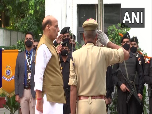Rajnath Singh hoists flag at his residence. (Photo/ANI)