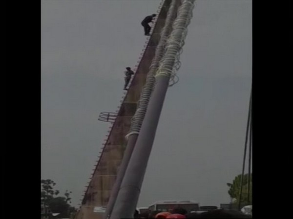Amit Chauhan, a Sub-inspector in City Patrol Unit of Uttarakhand Police saved a 'Kanwariya' who climbed atop cable bridge in Haridwar [Photo/ANI]