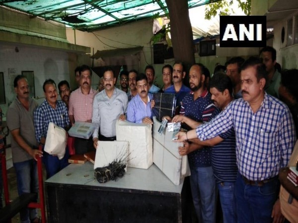 ATS officers with the seized items in Mumbai on Saturday. 