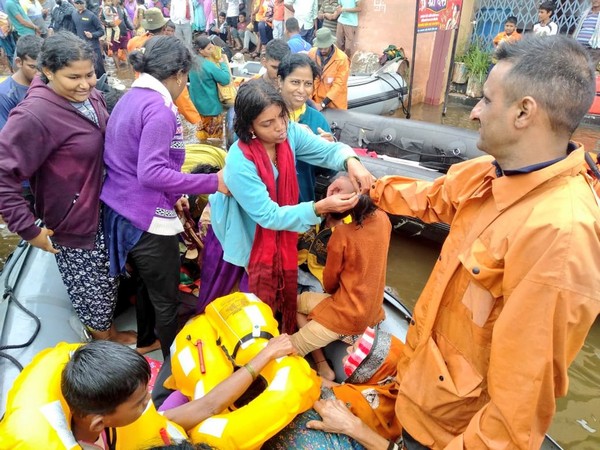A woman tying 'rakhi' on the wrist of a Navy person in Kolhapur. (Photo/Twitter@indiannavy)