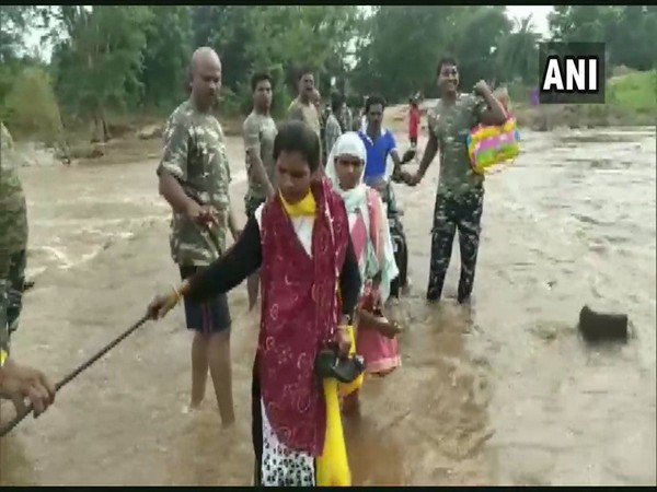CRPF personnel formed a human chain to help the locals cross a bridge. Photo/ANI