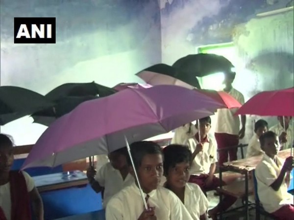 Children are forced to study under umbrellas due to leaking rooftops (File photo)