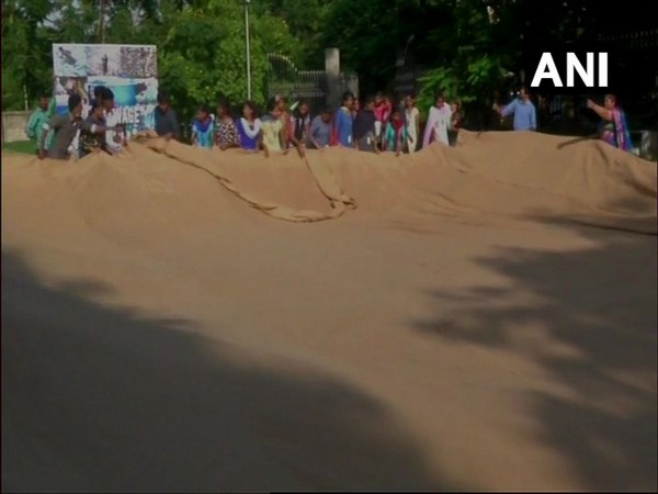 Volunteers, along with the nine visually challenged people, sewing the world's largest jute bag in an attempt to enter the Guinness World Record. Photo/ANI