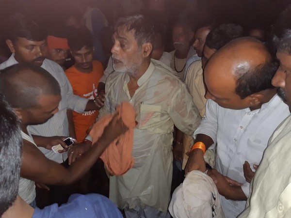 BJP MP Kripal Yadav being rescued by locals after he fell in flood-water in Patna. Photo/ANI