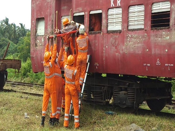 NDRF and KRCl are demonstrating the rescue activity by cutting window of the coach in the mock exercise at Verna Goods Yard in Goa today. Photo/ANI