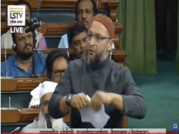 AIMIM MP Asaduddin Owaisi tearing a copy of the Citizenship (Amendment Bill) in the Lok Sabha on Monday. Photo/LSTV