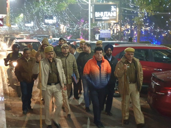 Police officials marching in an area in South Delhi on Thursday. 