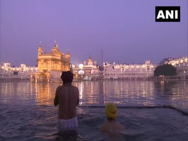 Punjab: Devotees take holy dip in 'Sarovar' at Golden Temple in Amritsar and offered prayers.