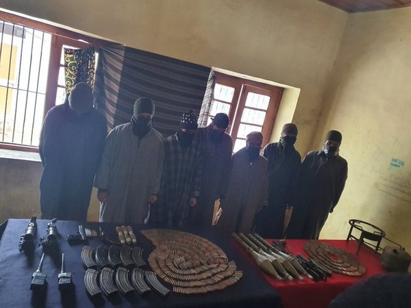 The accused along with arms and ammunition recovered from them in Bandipora on Saturday. Photo/ANI