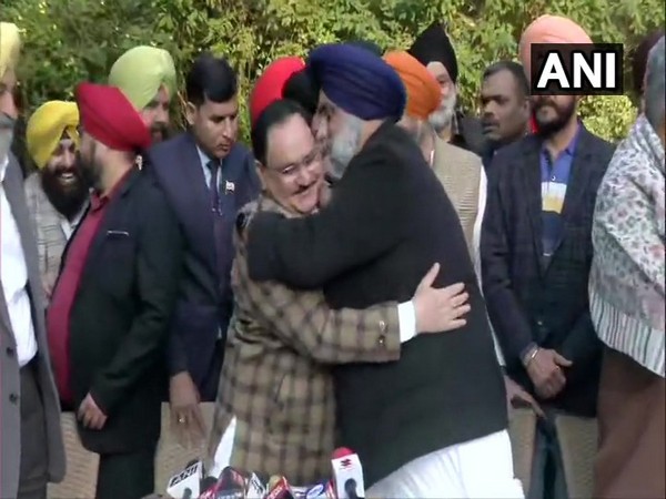 BJP president JP Nadda and SAD chief Sukhbir Singh Badal hugging each other at a press conference in New Delhi on Wednesday. Photo/ANI
