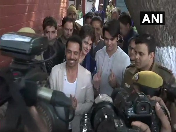 Congress general secretary Priyanka Gandhi Vadra, her husband Robert Vadra and son Raihan Rajiv Vadra flash their inked fingers outside a polling booth in Lodhi Estate on Saturday.