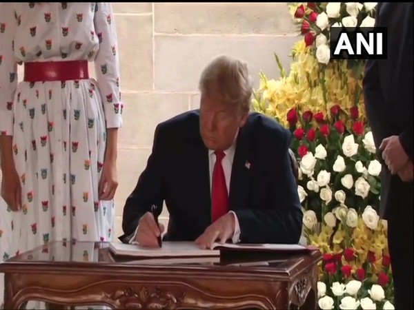 US President Donald Trump writing his message in the visitor's book at Rajghat on Tuesday.