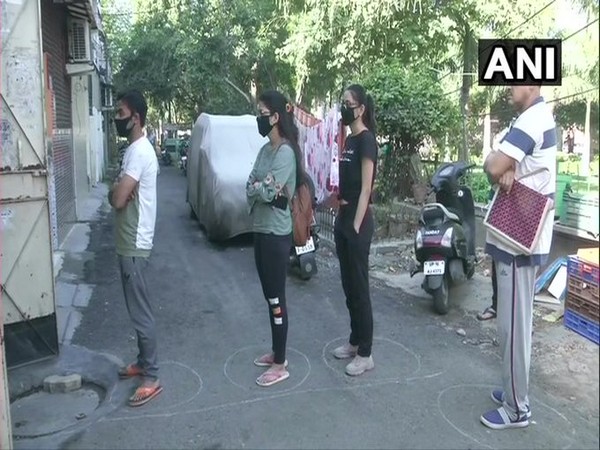 People in Noida, Uttar Pradesh practice social distancing amid COVID-19 outbreak on Wednesday.