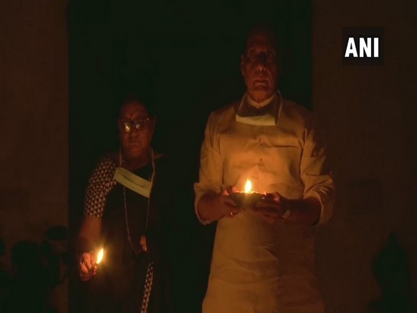 Defence Minister Rajnath Singh lights up earthen lamps along with his family in New Delhi on Sunday night.