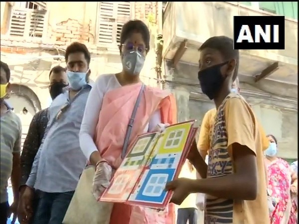 West Bengal Minister Dr Shashi Panja distributing ludo kits to children in Shyampukur, Kolkata, on Monday.