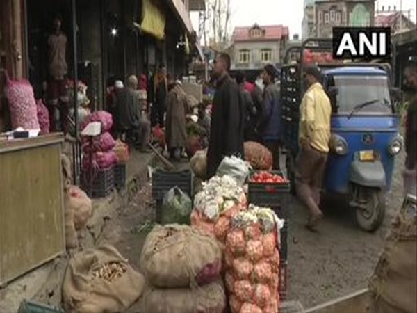People patiently standing in queues in Srinagar to buy vegetable [Photo/ANI]