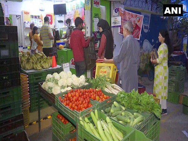 Customers in a Safal store at Patparganj, Delhi, practising social distancing