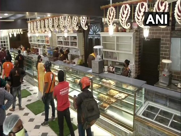 People buying sweets from a shop in Kolkata on Tuesday.