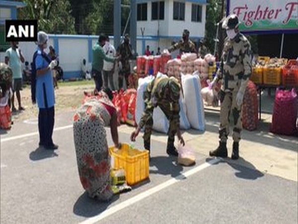 BSF personnel distribute food to people at India-Bangladesh border in West Bengal's Fulbari on Saturday. Photo/ANI