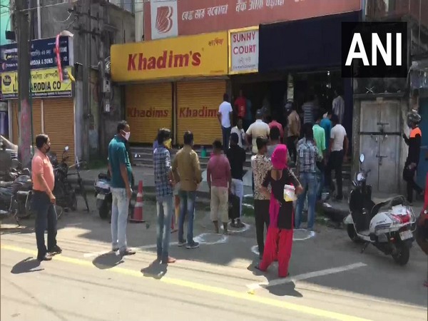 People line up outside liquor stores in Dibrugarh on Monday.