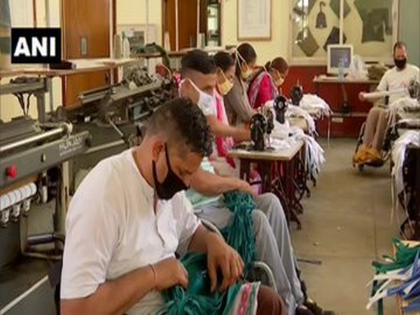 Retired paraplegic soldiers and their wives in Paraplegic Rehabilitation Center  making masks in Mohali [Photo/ANI]