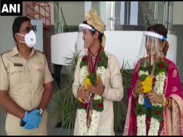 Aditya Singh and Neha Khushwaha talking to the policeman after their wedding in Pune on Sunday. Photo/ANI