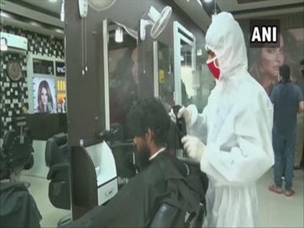Employees of a salon in Gurugram are attending customers wearing PPEs [Photo/ANI]