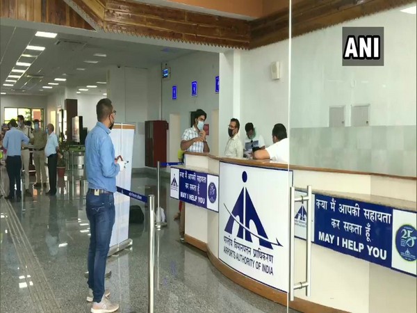 Passengers arrive at Kangra Airport as domestic fair travel resumes. 