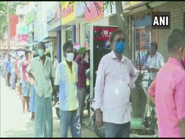 People queue up outside liquor stores in Puducherry on Monday