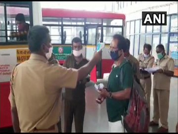 People undergoing thermal scanning before boarding buses in Karnataka. [Photo/ANI]