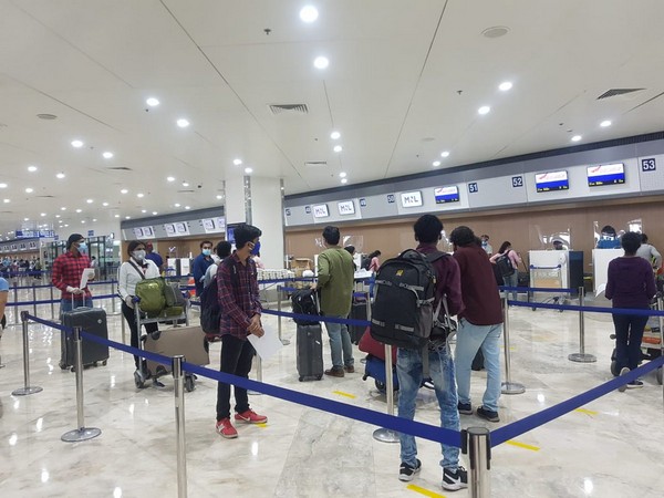 Passengers queue up for check-in after the thermal screening at Manila Airport