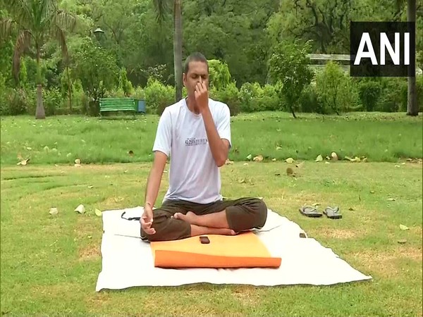 Man practices yoga in Lochi Garden ahead of the 6th International Yoga Day