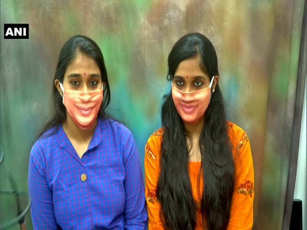 Two customers wearing customised face masks