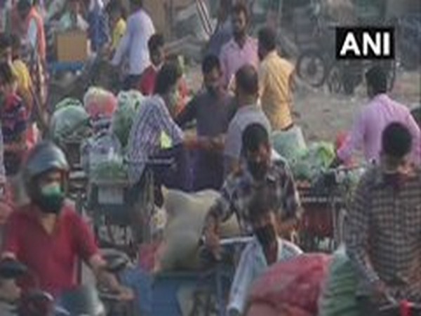 People arrive at Gazipur fruit and vegetable market to make purchases. [Photo/ANI]