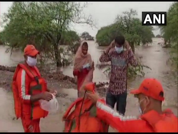 The duo was rescued by the National Disaster Response Force from the Und river in Gujarat after a flood-like situation. [Photo/ANI]