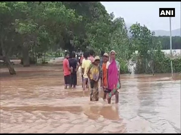 Visuals from Dhenkanal of locals wading through knew-length floodwater. (Photo/ANI)