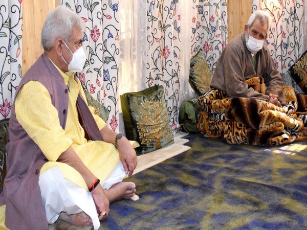 Lieutenant Governor Manoj Sinha with the father of slain advocate Babar Qadri.
