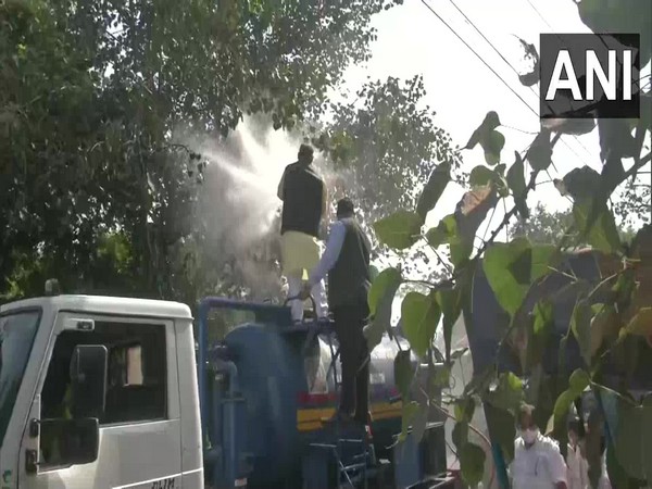 NDMC Mayor Jai Prakash waters trees in Karol Bagh on Thursday. (Photo/ANI)