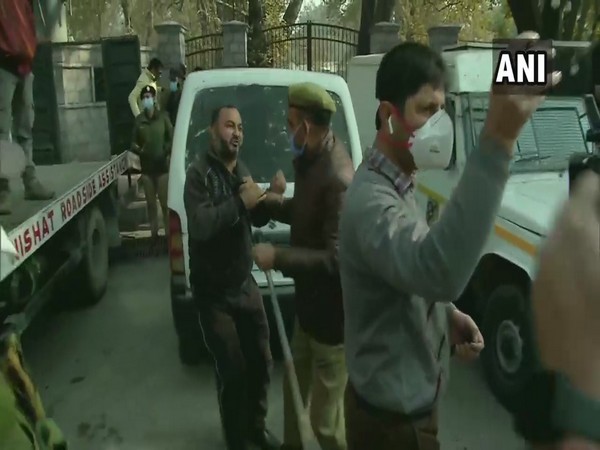 Police detain a PDP worker during a protest near Sports Complex in Srinagar on Thursday. (Photo/ANI)