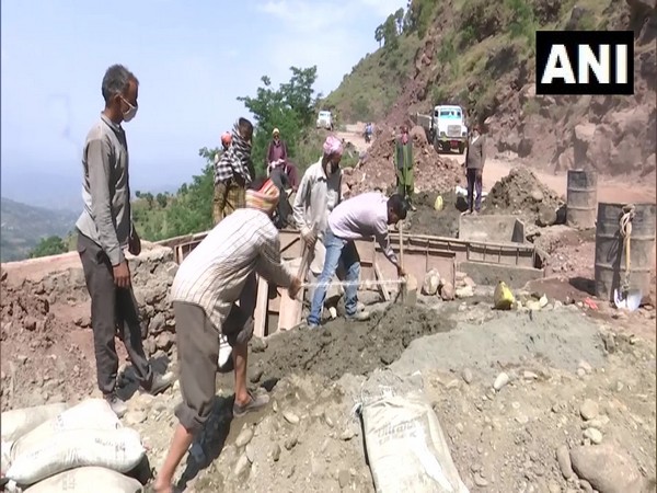 Locals of Drajj village working of a community development project on Monday. Photo/ANI