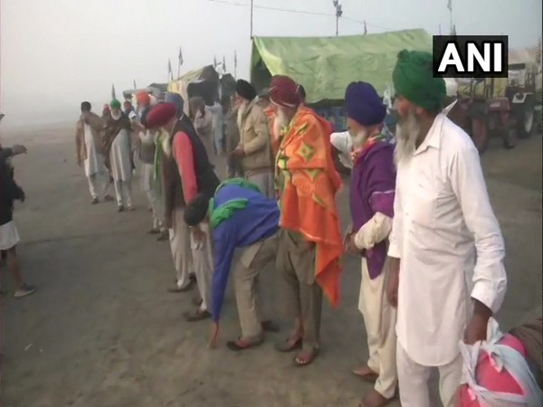 Farmers at Burari's Nirankari Samagam ground during their morning prayers on Tuesday. (Photo/ANI)