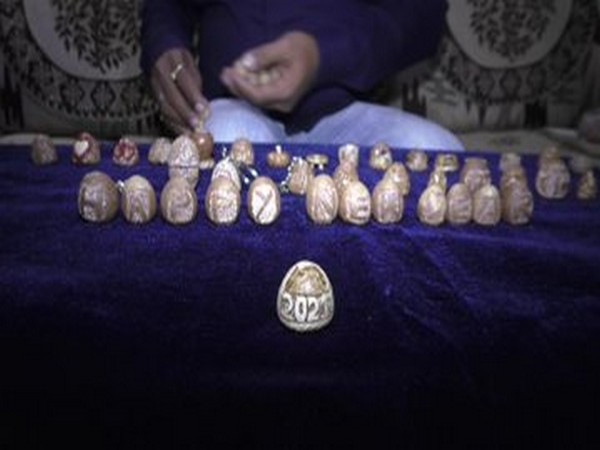 A miniature artist from Surat, Pavan Sharma has carved various things on betel nuts (Photo/ANI)