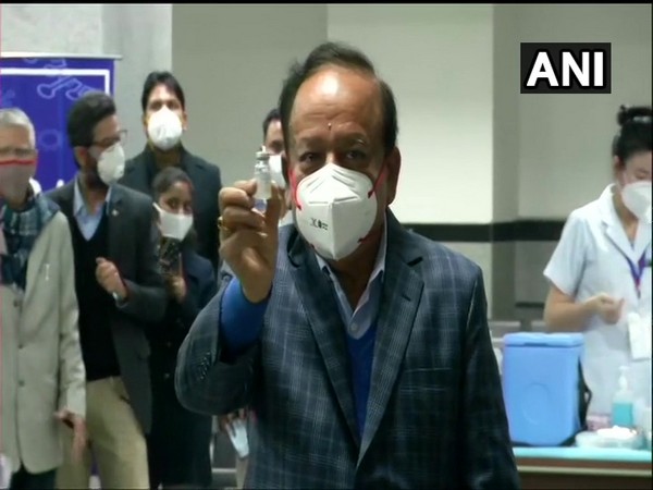 Union Minister Dr Harsh Vardhan holding up a COVAXIN dose (Photo/ANI)