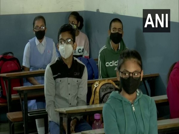 Students attend classes at an Ahmedabad school after schools across Gujarat reopened on Monday. [Photo/ANI]